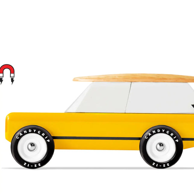 Toy car with a wooden surfboard on top and 'Candygrip' tires on a white background
