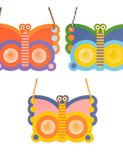 Three colorful butterfly-shaped decorations with strings on a white background