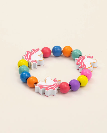 Colorful children's bracelet with unicorn charms and multicolored beads on a beige background