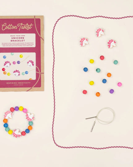 Unicorn bracelet making kit with colorful beads and packaging on a beige background
