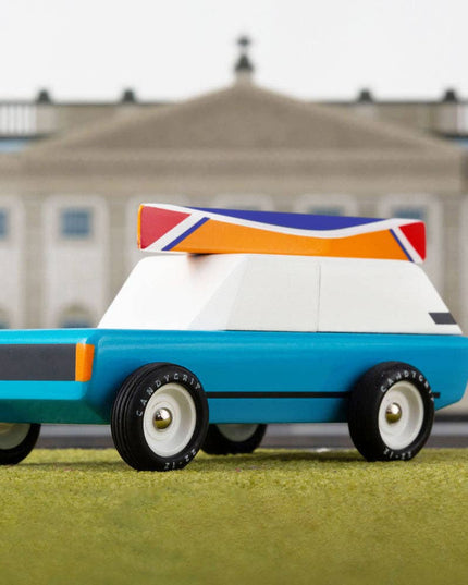 Toy car with a British flag design in front of a large building