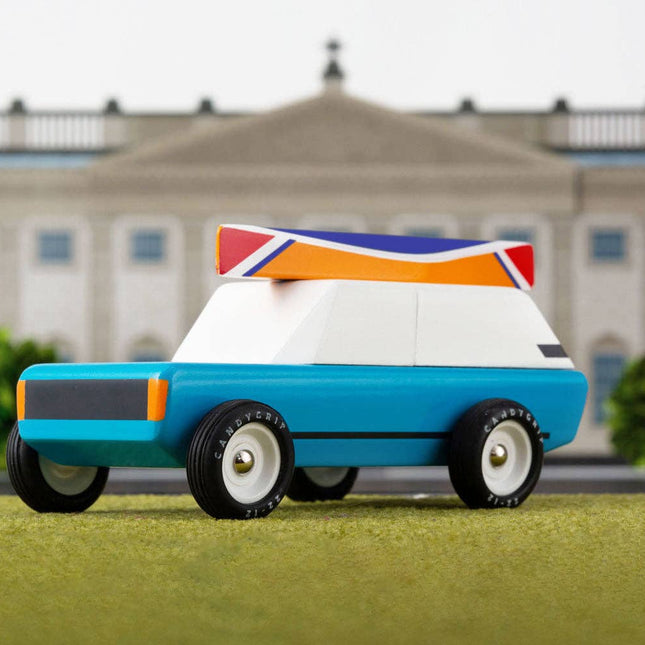 Toy car with a British flag design in front of a large building