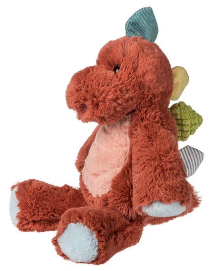 Plush dinosaur toy with a red-brown body, multi color details, and light blue feet pads on a white background