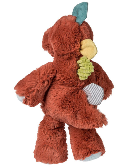 Plush toy resembling a dinosaur with a red body and blue, yellow, green details on a white background