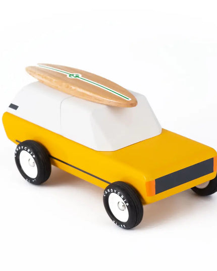 Toy car with a surfboard on top on a white background