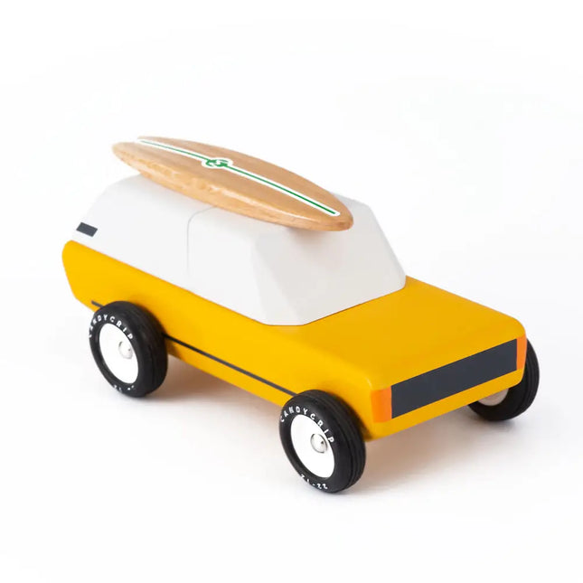 Toy car with a surfboard on top on a white background
