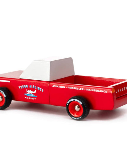 Red toy truck with a white cab top on a white background