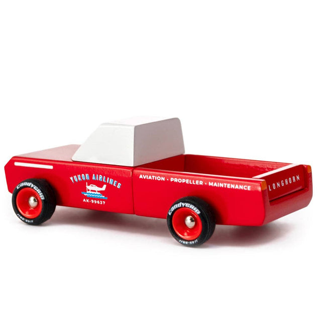 Red toy truck with a white cab top on a white background