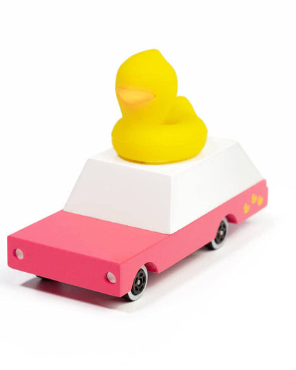 Pink toy car with a yellow rubber duck on a white background