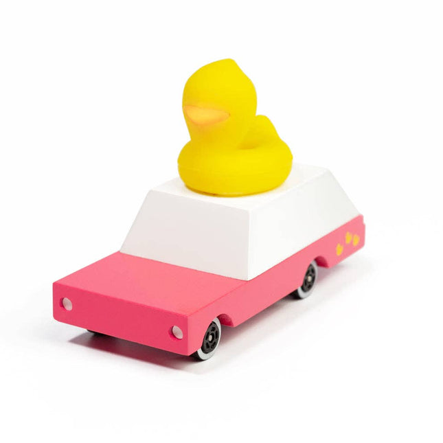 Pink toy car with a yellow rubber duck on a white background