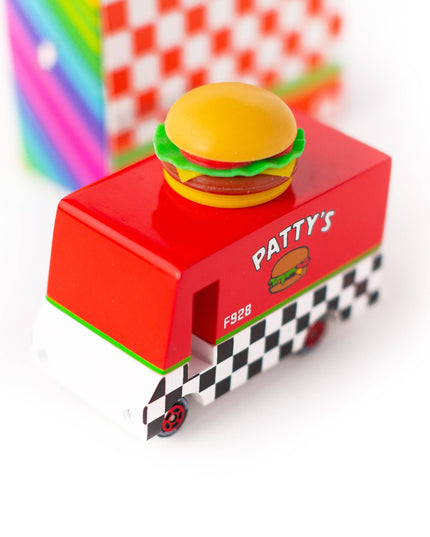 Toy burger truck with a hamburger on top, set against a colorful background.