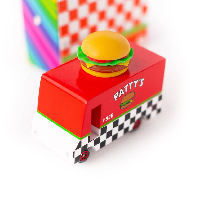Toy burger truck with a hamburger on top, set against a colorful background.