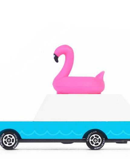 Toy truck with a pink flamingo floaty on a white background