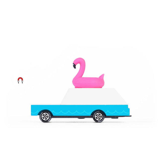 Toy truck with a pink flamingo floaty on a white background