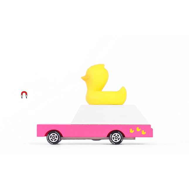 Yellow rubber duck on a pink car with a white background