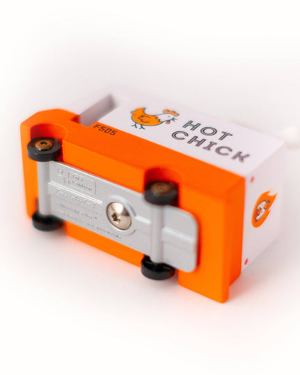Orange and silver device with 'Hot Chick' branding on a white background