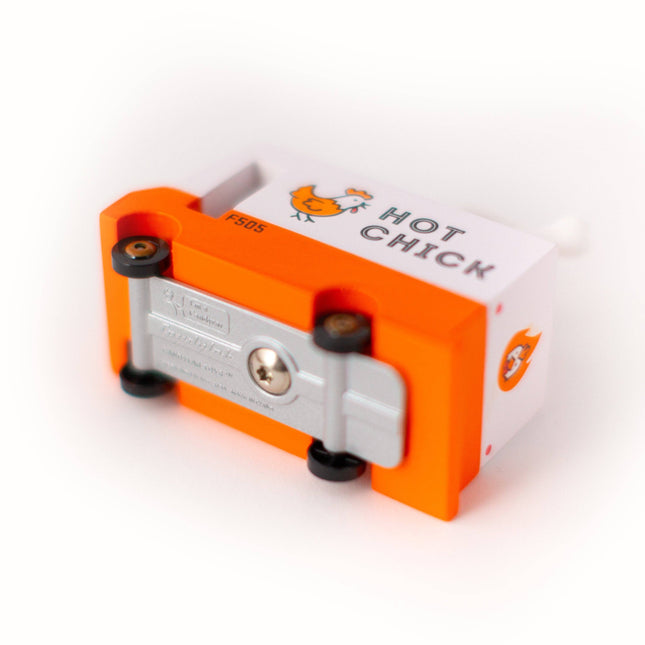 Orange and silver device with 'Hot Chick' branding on a white background