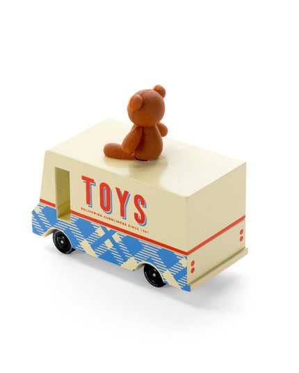 Toy truck with 'TOYS' on the side and a teddy bear on top against a white background