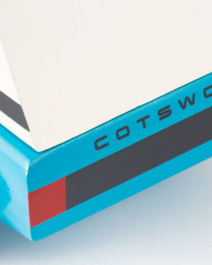 Close-up of a blue and white trailer with 'Cotswold' branding on a light gray background