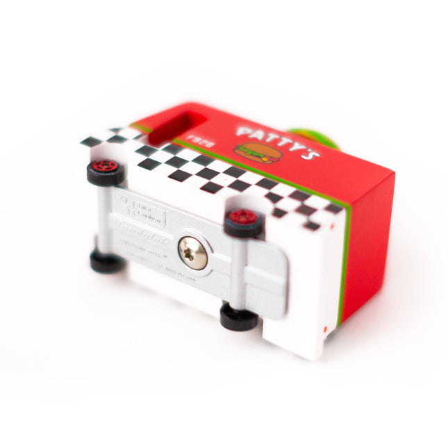 Small mechanical device with a red box featuring 'Patty's' branding on a white background