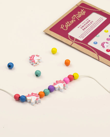 Colorful unicorn-themed beaded bracelet with packaging on a light background