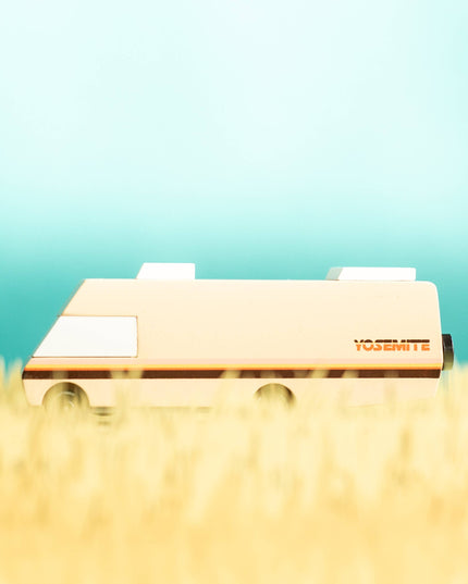 Small vehicle on grass with a gradient blue background