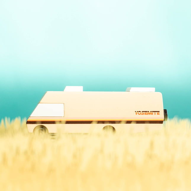 Small vehicle on grass with a gradient blue background