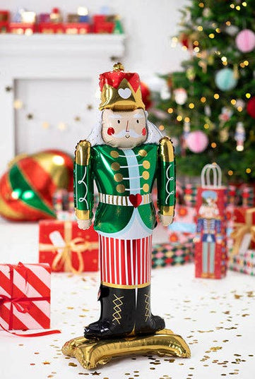 Decorative nutcracker figure in a festive setting with Christmas decorations.