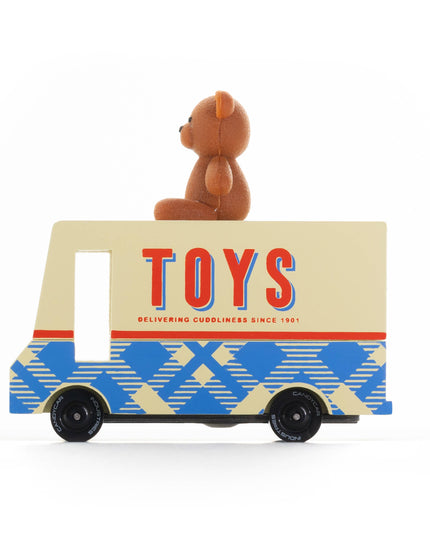 Toy truck with a teddy bear on top against a white background
