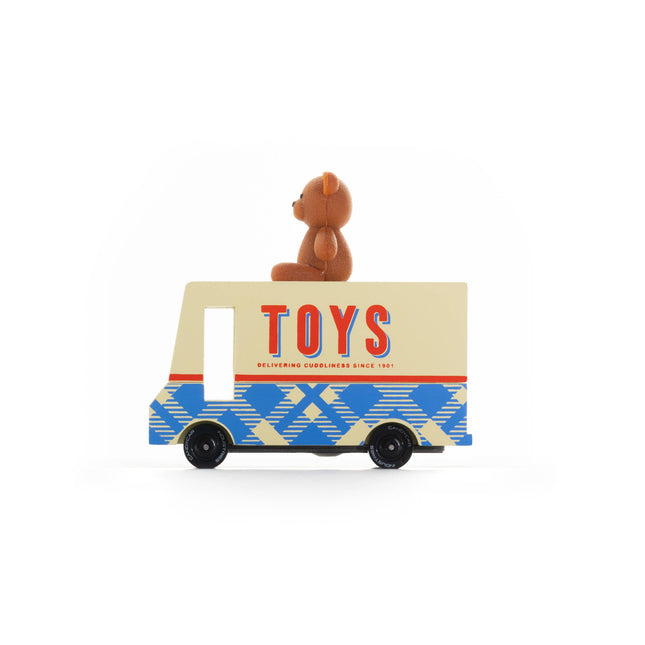 Toy truck with a teddy bear on top against a white background