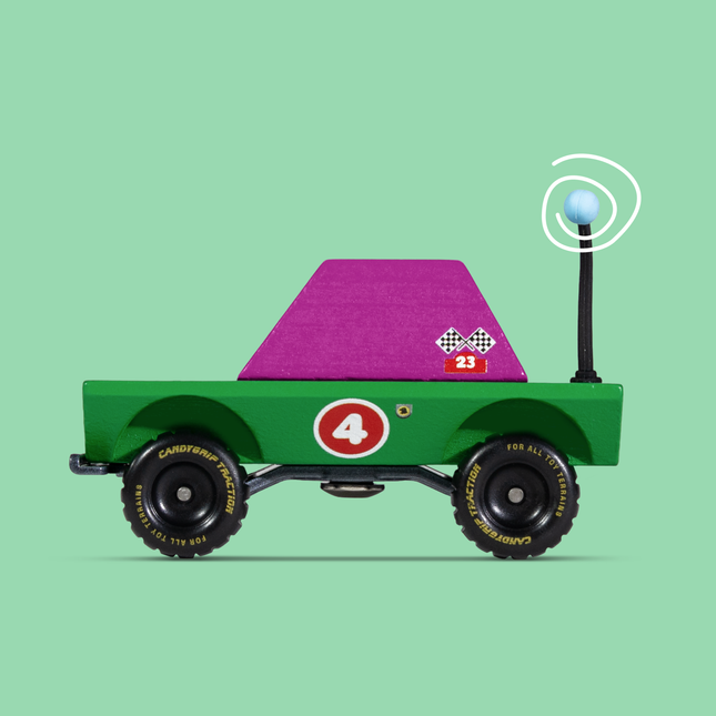 Toy truck with a purple flatbed on a green background