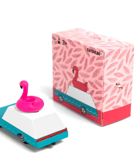 Toy car with pink flamingo floatie and branded box on a white background