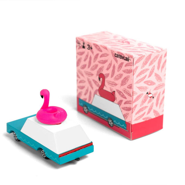 Toy car with pink flamingo floatie and branded box on a white background