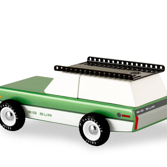 Green toy car with a black roof rack on a white background