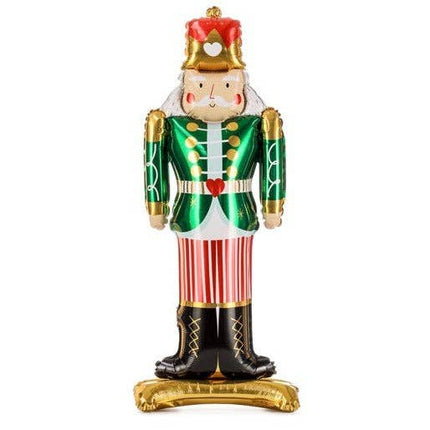 Decorative nutcracker figurine with green coat, red hat, and striped pants on a white background