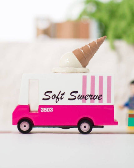 Toy ice cream truck with 'Soft Swerve' branding on a blurred indoor background