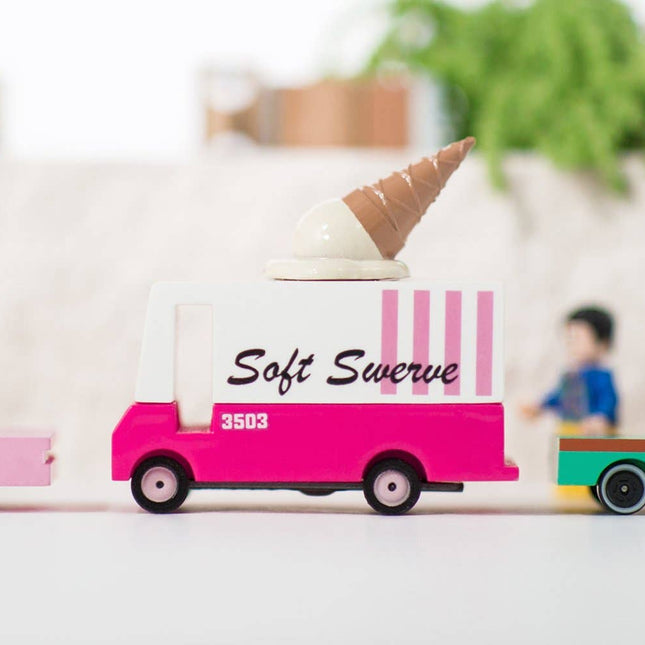 Toy ice cream truck with 'Soft Swerve' branding on a blurred indoor background