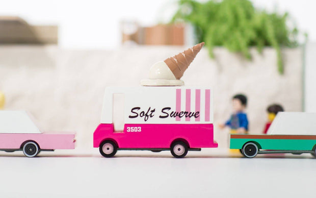 Toy ice cream truck with 'Soft Swerve' branding on a blurred indoor background