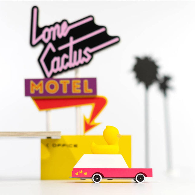 Decorative sign with 'Lone Cactus Motel' design on a white background