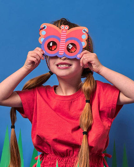 Child wearing a butterfly mask against a blue background