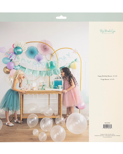 Party setup with balloons and decorations on a cardboard backing