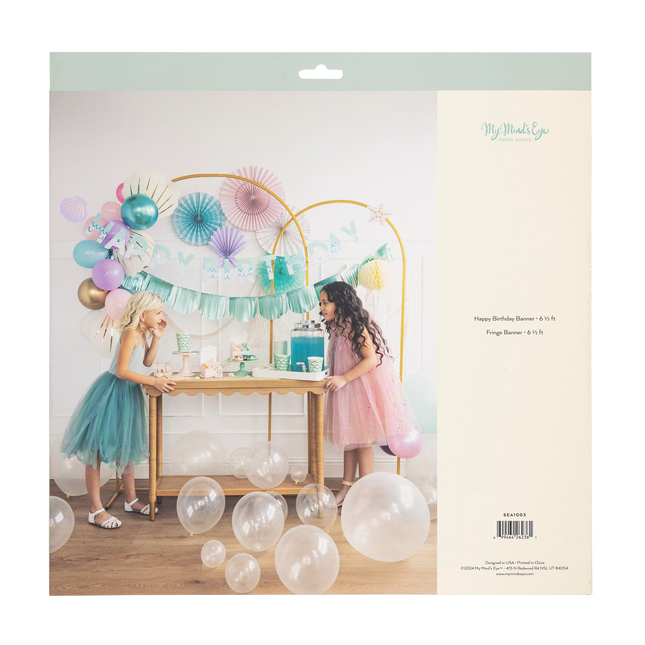 Party setup with balloons and decorations on a cardboard backing