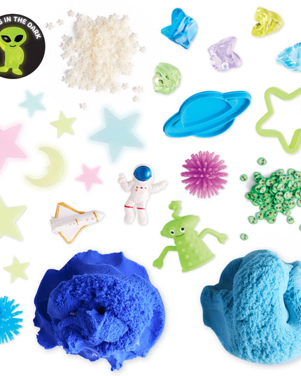 Assorted space-themed toys and items including blue slime, alien figures, and glow-in-the-dark stars on a white background.