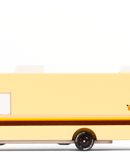 Toy van with a beige body and black wheels on a white background