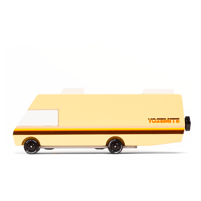 Toy van with a beige body and black wheels on a white background