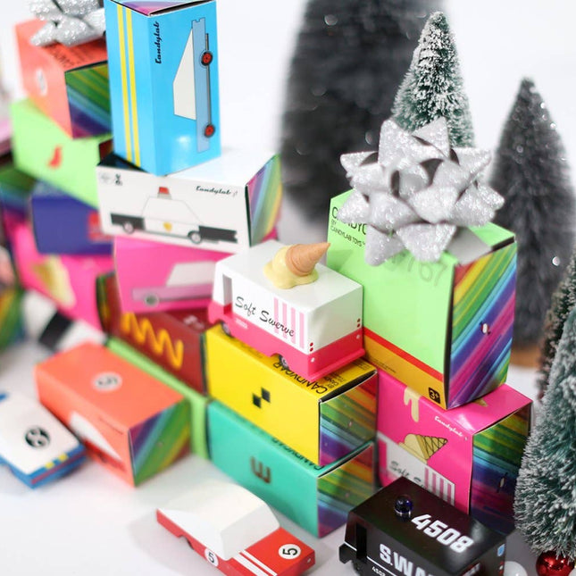 Colorful gift boxes with Christmas trees and decorative items on a white background
