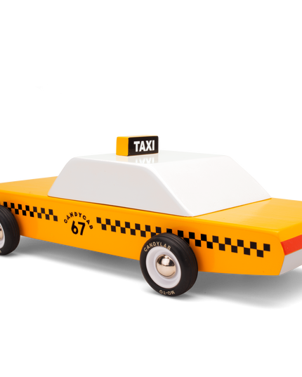 Toy taxi model with yellow body, black checkered pattern, and white top on a white background