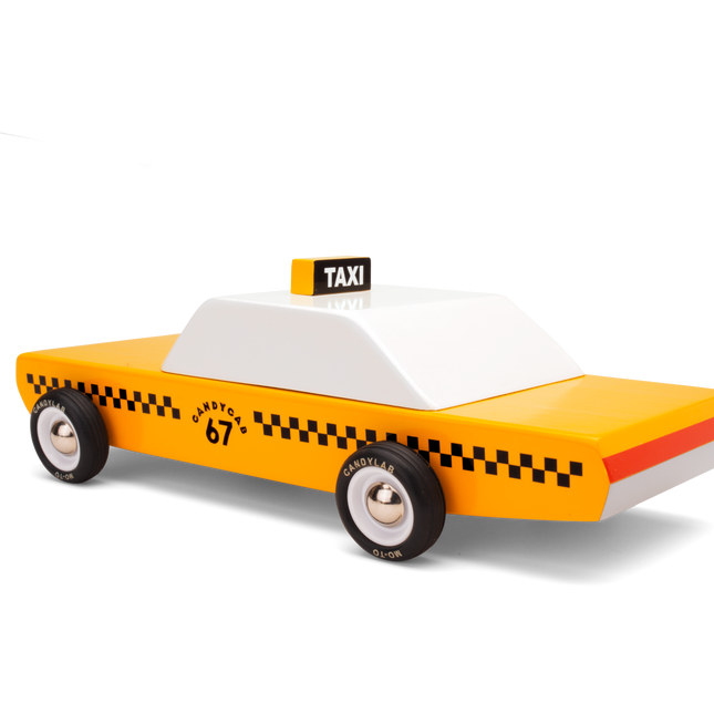 Toy taxi model with yellow body, black checkered pattern, and white top on a white background
