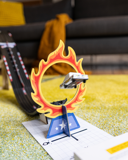 Toy car on a track with a flame-shaped obstacle