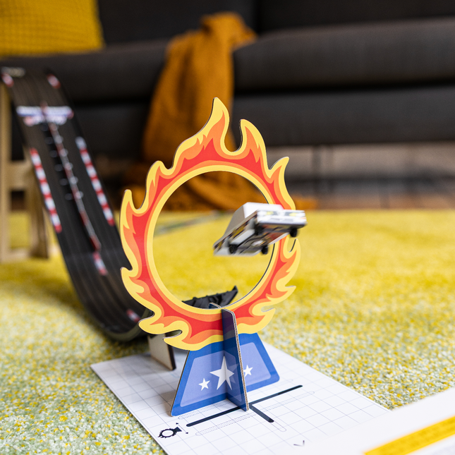 Toy car on a track with a flame-shaped obstacle